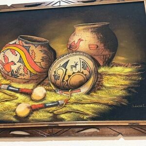 The image is of an original Native American sand art painting by an artist named